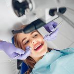Beautiful girl sitting in the dentist's office