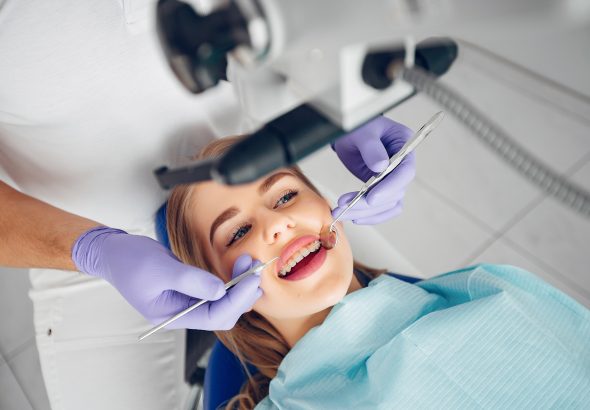 Beautiful girl sitting in the dentist's office
